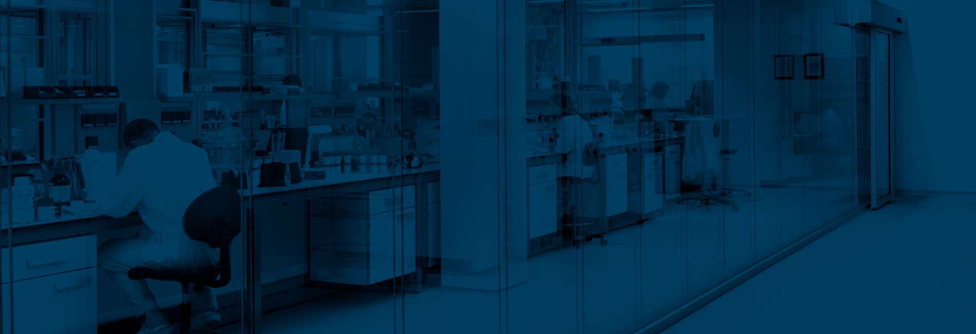 Blue image of people at work on laboratory benches designed by Burdinola.
